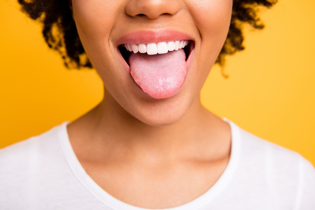 A young woman playfully sticks her tongue out